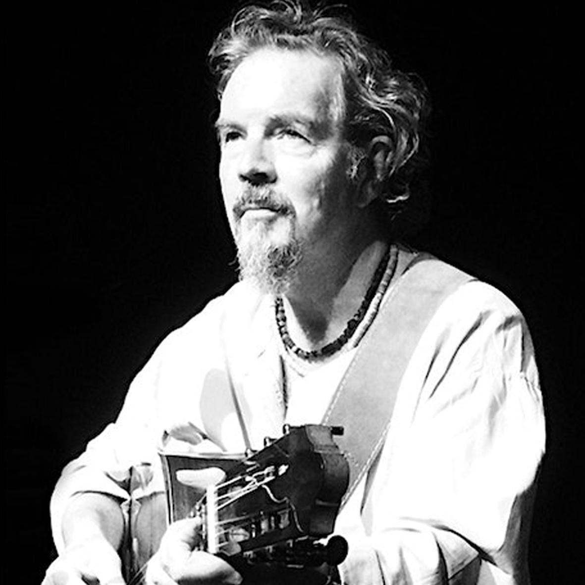 Picture of artist holding guitar