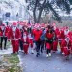 people dressed as father christmas running
