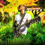 man with guitar amongst jungle plants