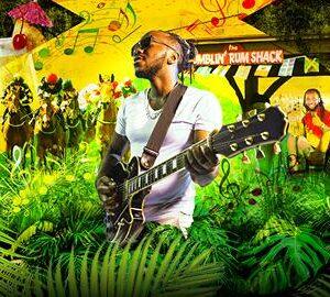 man with guitar amongst jungle plants